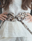 Video: Model wearing the Esquel Belt in speckled hair-on calfskin over a white dress, handcrafted in Argentina.