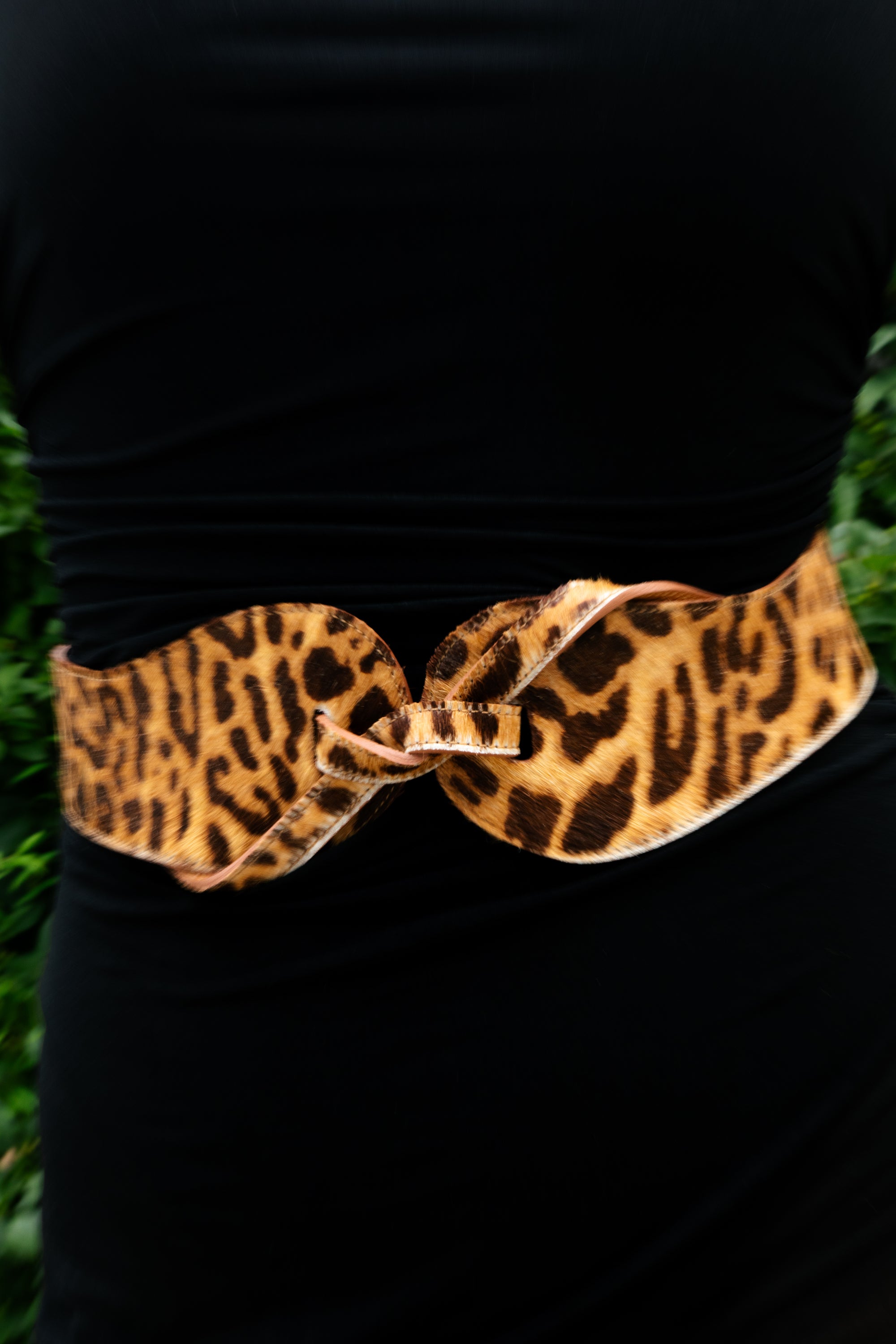 Close-up of the Esquel Belt in animal print, styled over black.